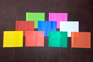 Nine colorful flags on a dark background.